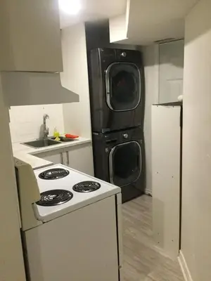 a kitchen with a stove and a refrigerator at Lower Unit Entire Apartment in Cambridge
