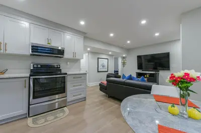 a kitchen and living room with a couch and a table at 2 Bedroom Private Suite-Parking-Near Hospital and Airport in Oakville