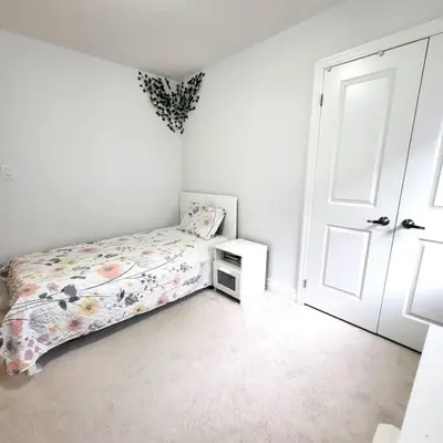 a small bedroom with a bed and a door at Spacious 4 Bedroom House in Angus in Angus
