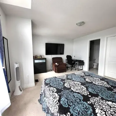 a bedroom with a bed and a flat screen tv at Spacious 4 Bedroom House in Angus in Angus