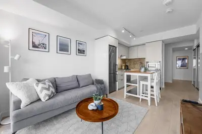 a living room with a couch and a table at RentX Downtown 2-Bed Suite Gym WiFi in Toronto