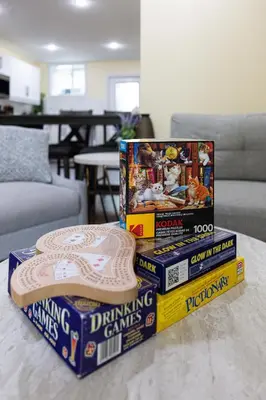 a pile of games stacked on top of each other on a table at Elegant & Private Apartment - Short Walk From Downtown in London