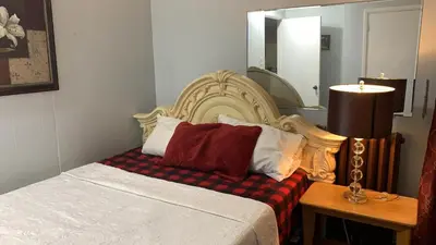a bedroom with a bed with a large headboard at Marmora and Lake Inn Apartment-Sleeps 5 guests in Marmora