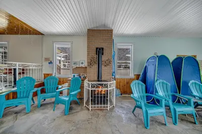 a room with blue chairs and a fireplace at Marmora and Lake Inn Apartment-Sleeps 5 guests in Marmora