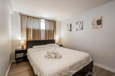 a bedroom with a bed with two teddy bears on it at Modern & Spacious 2BR 2BA Suite All Amenities Included in Brampton