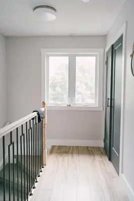 an empty hallway with a window and a staircase at Sandbanks Cottage on Sheba's Island - 5 min drive, pet friendly in West Lake