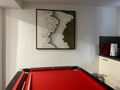 a pool table in a room with a picture on the wall at cozy private guest suite in Richmond Hill