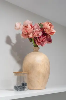 a vase with pink flowers sitting on a shelf at Haven Suite in London, On 2Br, 1Bath with free washer and dryer in London