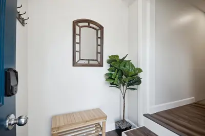 a hallway with a mirror and a plant at Haven Suite in London, On 2Br, 1Bath with free washer and dryer in London