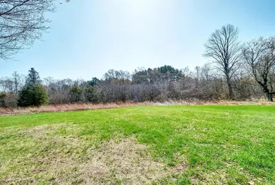 a large green field with trees in the background at The Marigold PEC Family Farmhouse country escape in West Lake
