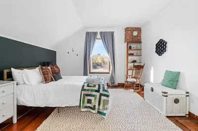 a bedroom with a bed and a window at The Marigold PEC Family Farmhouse country escape in West Lake