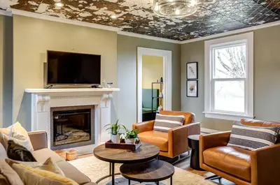 a living room with a fireplace and a tv at From HGTV Marigold Suite in county farmhouse in West Lake