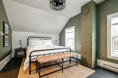 a bedroom with green walls and a bed with a bench at From HGTV Marigold Suite in county farmhouse in West Lake