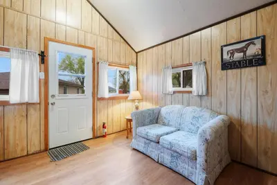 a living room with a couch and a door at Enjoy Relax at Rice Lakes in Bailieboro