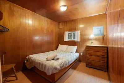 a small bedroom with a bed and a dresser at Dive into Nature at Rice Lake in Bailieboro