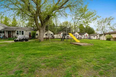 a playground in a yard with a yellow slide at Dive into Nature at Rice Lake in Bailieboro