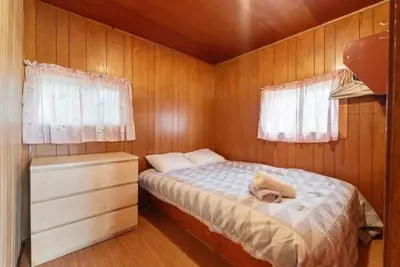 a small bedroom with a bed and a dresser at Dive into Nature at Rice Lake in Bailieboro