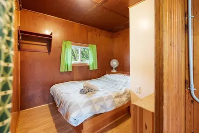 a bed in a small room with a window at Enjoy The Outdoors at Rice Lakes in Bailieboro