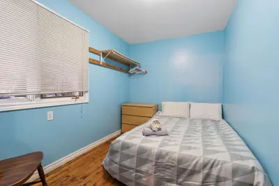 a bedroom with a bed with a blue wall at Beautiful Lake Views in Nature in Bailieboro