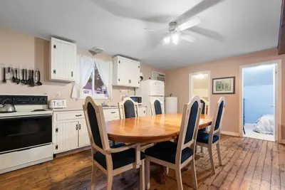 a kitchen with a wooden table and chairs around it at Beautiful Lake Views in Nature in Bailieboro