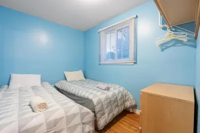 a blue room with two beds and a window at Beautiful Lake Views in Nature in Bailieboro