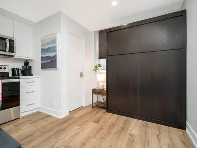 a kitchen with a large sliding door in a room at Cozy Studio Apt - Corktown Hamilton - Near DT in Hamilton