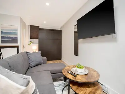 a living room with a couch and a table at Cozy Studio Apt - Corktown Hamilton - Near DT in Hamilton