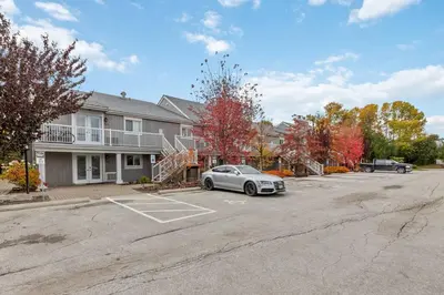 a car parked in a parking lot in front of a house at Whispering Pines Escape in Collingwood