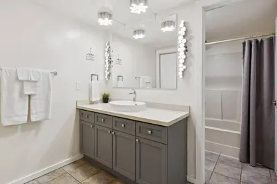 a bathroom with a sink and a mirror and a shower at Whispering Pines Escape in Collingwood