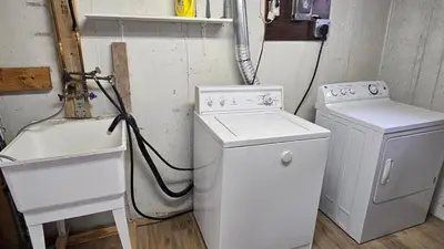 a laundry room with a washing machine and a sink at Home in Niagara region in St. Catharines