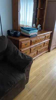 a dresser and a couch in a living room at Private Rooms, Free Parking, Full Kitchen, Best Prices in Town- York University Heights in Toronto