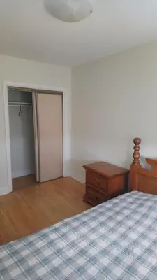 a bedroom with a bed and a dresser and a door at Private Rooms, Free Parking, Full Kitchen, Best Prices in Town- York University Heights in Toronto