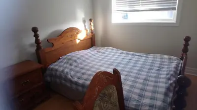 a small bedroom with a bed and a window at Private Rooms, Free Parking, Full Kitchen, Best Prices in Town- York University Heights in Toronto