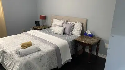 a bedroom with a bed with two pillows on it at Masterbedroom with Private washroom in Mississauga