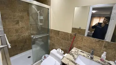 a man taking a picture of a bathroom at Masterbedroom with Private washroom in Mississauga
