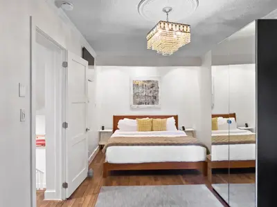 a bedroom with a bed and a chandelier at Hot Tub Haven in Toronto