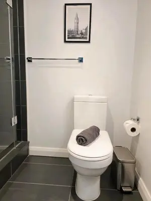 a bathroom with a toilet with a towel on it at Elegant 2BR & 2BA Retreat in Prime Yorkville, Downtown in Toronto