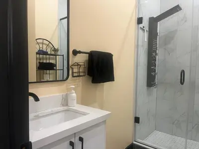 a bathroom with a white sink and a shower at The Grassy Oasis in Brampton