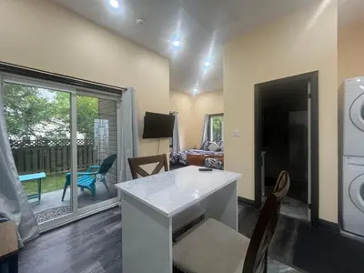 a kitchen and living room with a view of a patio at The Grassy Oasis in Brampton
