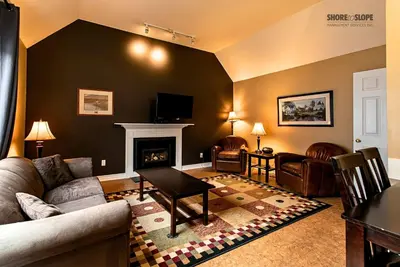 a living room with a couch and a fireplace at Mountain View Villas One Bedroom Suite in Collingwood