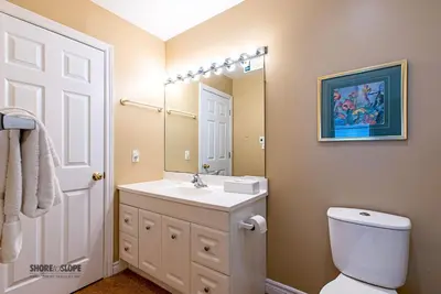 a bathroom with a sink and a toilet and a mirror at Mountain View Villas One Bedroom Suite in Collingwood