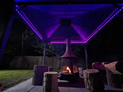 a fireplace under a tent with purple lights at Modern Tiny Wood Cottage 04 in Wasaga Beach