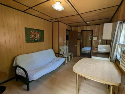 a hospital room with a bed and a table at Tiny Wood Cottage 08 in Wasaga Beach
