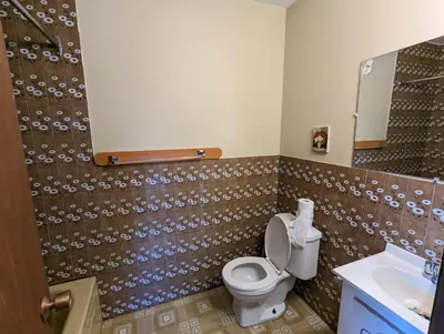 a bathroom with a toilet and a sink at Tiny Wood Cottage 17 in Wasaga Beach