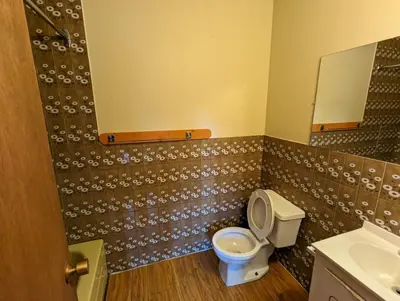 a bathroom with a toilet and a sink at Tiny Wood Cottage 19 in Wasaga Beach