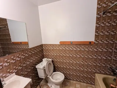 a bathroom with a toilet and a sink at Tiny Wood Cottage 23 in Wasaga Beach