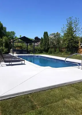 a swimming pool with two benches and a gazebo at Alba Cottage with Brand New Pool in Queenston