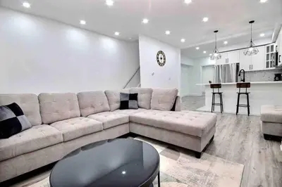 a large living room with a couch and a table at Modern Luxury Home next to Tim Hortons Field in Hamilton