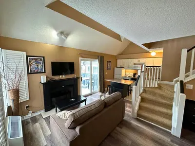 a living room with a couch and a fireplace at Mountain Loft Suite with Pool and Hot Tub in Blue Mountains