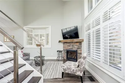 a living room with a fireplace and a tv at The Family Escape Townhome in Collingwood